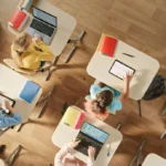 Elementary students sitting in a computer science classroom — representing a typical learning setup that reflects how many weeks in a school year students attend.