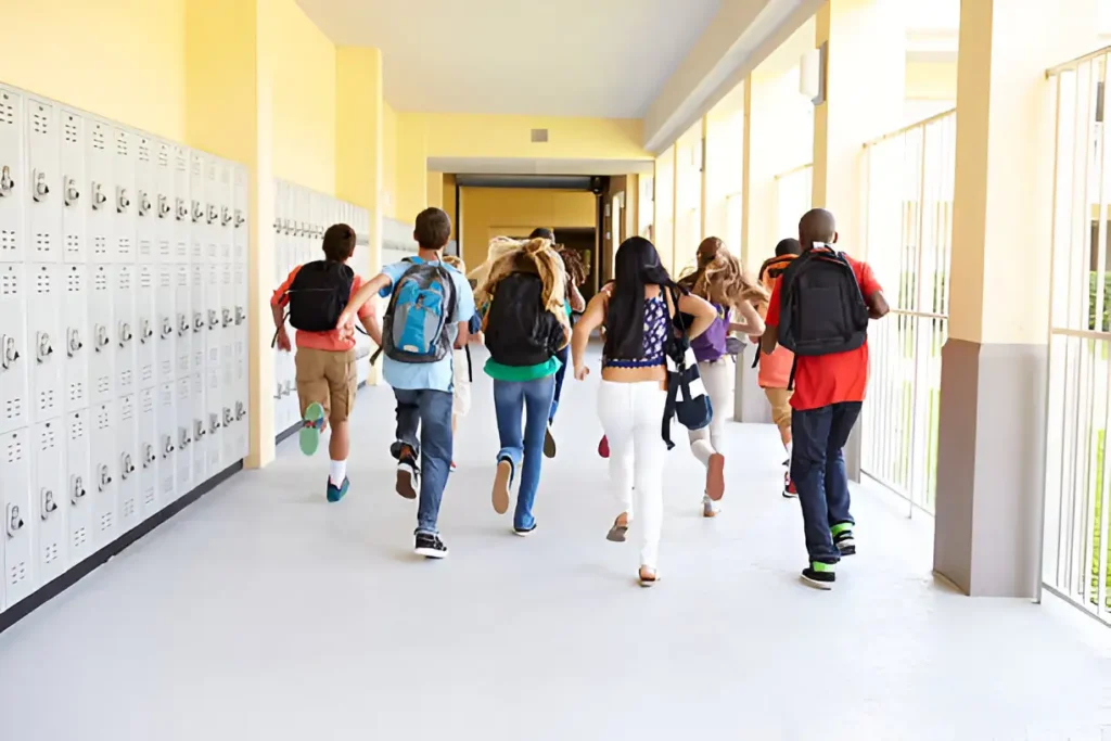 High school students running in a school hallway, illustrating the typical routine and energy during the academic calendar — related to how many weeks in a school year.