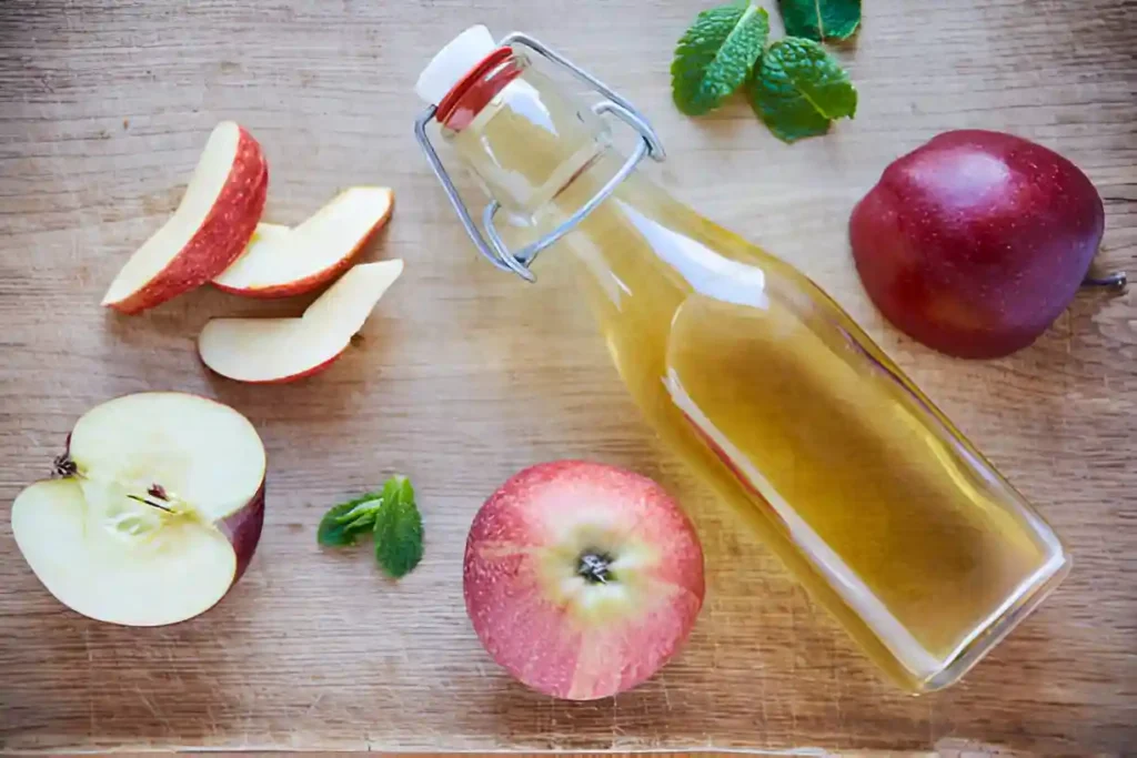Apple cider vinegar in spoon used for relieving tooth pain naturally