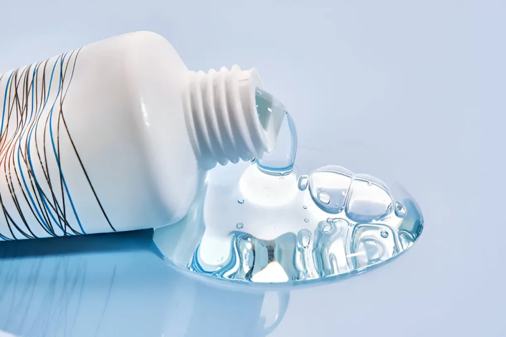Close-up of person applying numbing gel to gums for pain relief